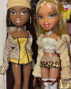 two dolls are standing next to each other