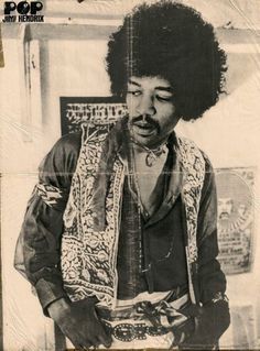 a black and white photo of a man with an afro