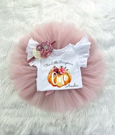 a pink tutu skirt and white shirt that says, there is no pumpkin on it