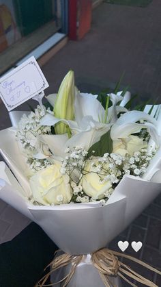 a bouquet of white roses and baby's breath