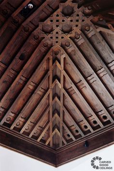 the ceiling is made out of wood and has an intricate design on it's side