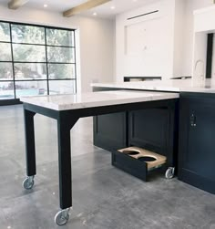 a kitchen with an island in the middle and two drawers on each side that are open