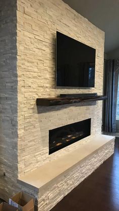 a fireplace with a flat screen tv mounted above it