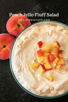 peach jello fluff salad in a glass bowl with two peaches on the side