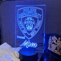 an illuminated police department sign next to a hat and other items on a table in front of a chair