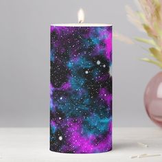 a purple and blue candle sitting on top of a table