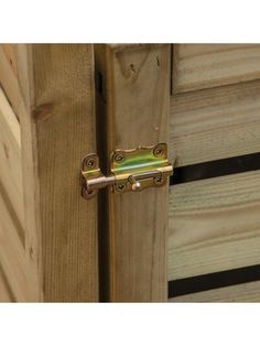 a close up of a door handle on a wooden cabinet