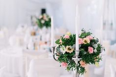 the centerpieces are decorated with flowers and candles