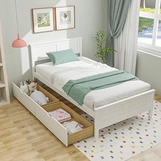 a white bed with drawers underneath it in a bedroom