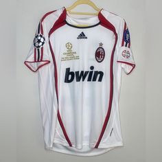 a soccer jersey hanging on a wooden hanger