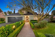 a house that has hedges in front of it