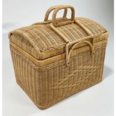 a wicker picnic basket with handles and handle