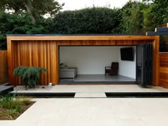 an outdoor living area with wooden walls and sliding doors