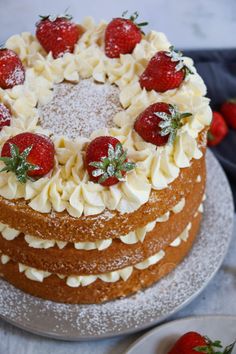 a cake with white frosting and strawberries on top