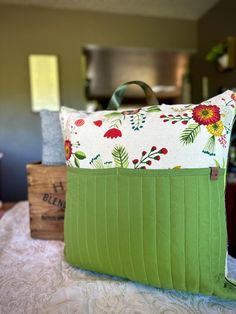 a green purse sitting on top of a bed