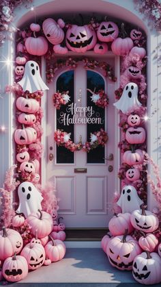 a door decorated for halloween with pumpkins and ghost heads on the front porch, surrounded by pink foliage