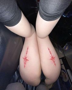 two women with red tattoos on their butts