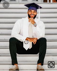 a man wearing a graduation cap and gown sitting on steps with his hand under his chin