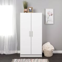 a white cabinet sitting in the corner of a living room next to a rug and window