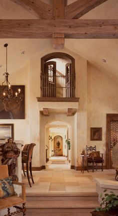 a living room filled with furniture and a tall vase sitting on top of a hard wood floor