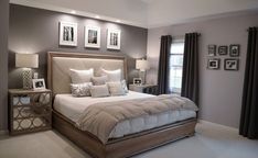 a bedroom with a large bed and pictures on the wall