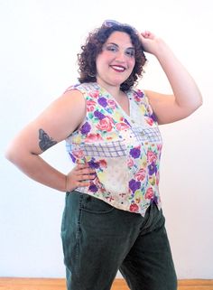 This is a very cute 90s boho floral vest by Passports of Pier 1 Imports! It's a lightweight, breezy gauze rayon vest that could also be worn as a sleeveless top. It has a painterly flower print in purple, dusty rose pink, yellow and green, with a blue windowpane design on a beige background. It has a lapped V neck, generously cut arm holes, a hem that comes to two points in the front, and it closes with five marbled tan front buttons.The vest is in good clean condition, no flaws noted. The label Floral Vest, 90s Boho, Floral Vests, Dusty Rose Pink, 90s Floral, Pier 1 Imports, Beige Background, Yellow And Green, Pier 1