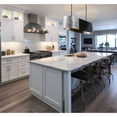 a large kitchen with an island in the middle and lots of counter space on one side