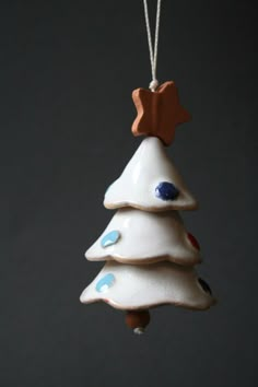 a ceramic christmas tree ornament hanging from a string