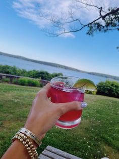 a person holding a drink in their hand