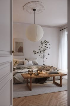 a living room with a couch, coffee table and lamp hanging from the ceiling above it