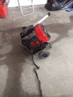 a red shopping cart sitting on top of a floor