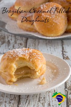 a close up of a doughnut on a plate with powdered sugar around it