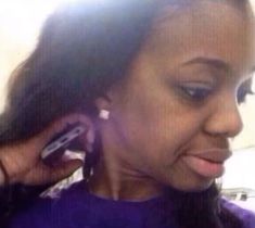 a close up of a person talking on a cell phone while holding a cell phone to her ear