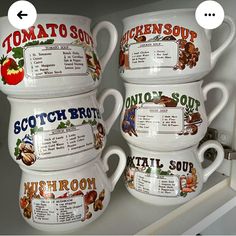 three white coffee mugs are stacked on top of each other with information about different foods