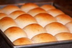 a pan filled with bread rolls sitting on top of a counter