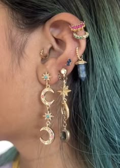 a close up of a person with ear piercings on their ears and wearing jewelry