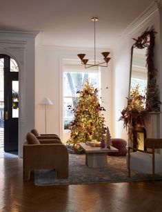 a living room filled with furniture and a christmas tree