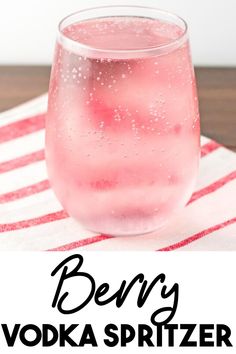 a pink drink in a glass with the text super easy mixed berry vodka spritzer