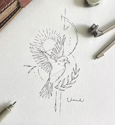 a drawing of a bird on top of paper next to some pens and ink rollers