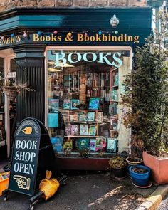 a book shop with lots of books on the front and shelves in the window for sale