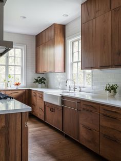 a kitchen with wooden cabinets and white counter tops