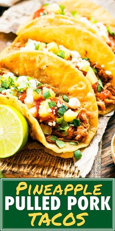 three pulled pork tacos sitting on top of a cutting board with lime wedges