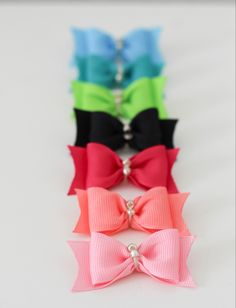 four different colors of bows on a white background