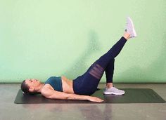 a woman is doing an exercise on a mat