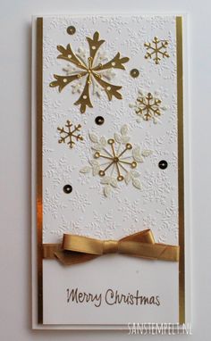 a christmas card with snowflakes on it and a gold bow in the middle