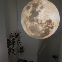 a full moon is projected on the wall