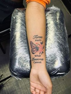 a woman's arm with a tattoo that says time heals what blossoms cannot