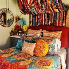 a bed covered in lots of colorful pillows