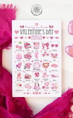 a pink valentine's day printable calendar on a table with hearts and ribbons