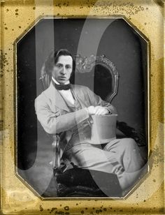 an old photo of a man sitting in a chair